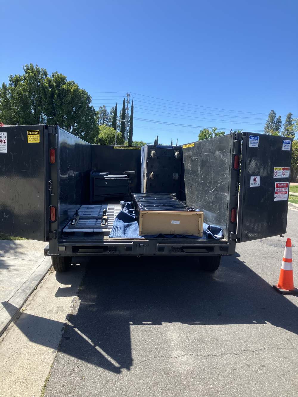 Padded and wrapped furniture loaded carefully for a commercial move in Northridge